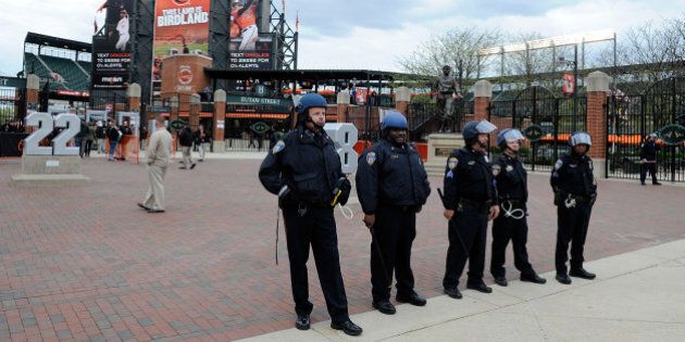 BALTIMORE, MD - APRIL 27: Police stand watch outside Oriole Park at Camden Yards before the game was postponed between the Baltimore Orioles and the Chicago White Sox on April 27, 2015 in Baltimore, Maryland. The move comes amid violent clashes between police and youths, according to news reports, the aftermath of the death of Freddie Gray on April 19 after suffering a fatal spinal injury while in police custody. (Photo by Greg Fiume/Getty Images)