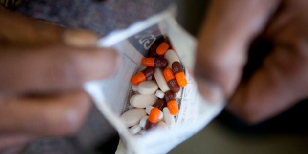 CAPE TOWN, SOUTH AFRICA - JUNE 3: A man who is a stable patient diagnosed with the HIV virus and who is in a support group, called an adherence club, holds his ARV drugs at Ubuntu Clinic in Kayelitsha township, on June 3, 2013 in Cape Town, South Africa. The clubs were the idea of MSF, Doctors Without Borders, to provide a quicker method for patients to get their ARV drugs and to provide peer support. The group meets once every two months. (Photo by Melanie Stetson Freeman/The Christian Science Monitor via Getty Images)