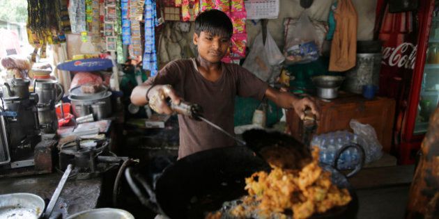 A child works at a snack shop in Lucknow, India, Wednesday, June 1, 2016. (AP Photo/Rajesh Kumar Singh)