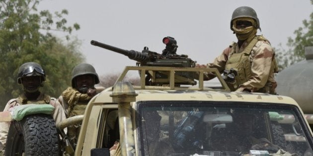 Nigerien army forces patrol in pickup trucks near Malam Fatori on April 3, 2015, after the town in north-eastern Nigeria was retaken from Boko Haram by troops from Chad and Niger. AFP PHOTO / PHILIPPE DESMAZES (Photo credit should read PHILIPPE DESMAZES/AFP/Getty Images)