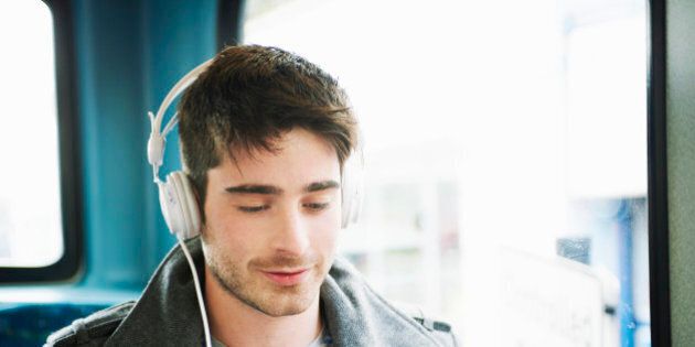 man listening to music with headphones and mobile