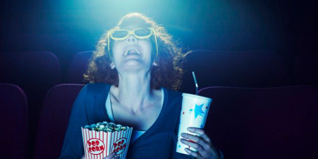 Woman enjoying movie at cinema