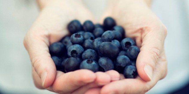 A woman offers blueberries