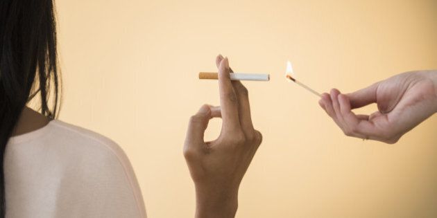 Man lighting woman's cigarette
