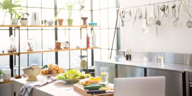 Interior of domestic kitchen with vegetables on kitchen counter