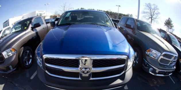 FILE - In this Jan. 5, 2015 file photo, Ram pickup trucks are on display on the lot at Landmark Dodge Chrysler Jeep RAM in Morrow, Ga. The major automakers report April sales on Friday, May 1, 2015. (AP Photo/John Bazemore, File)
