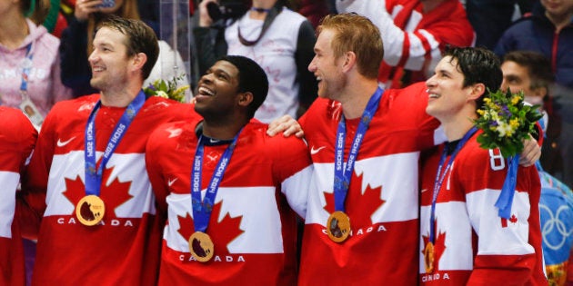 Canada forward Sidney Crosby, far right, stands with teammates for the Canadian national anthem after beating Sweden 3-0 in the men's gold medal ice hockey game at the 2014 Winter Olympics, Sunday, Feb. 23, 2014, in Sochi, Russia. (AP Photo/Julio Cortez)