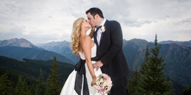 Wedding couple kissing on mountain