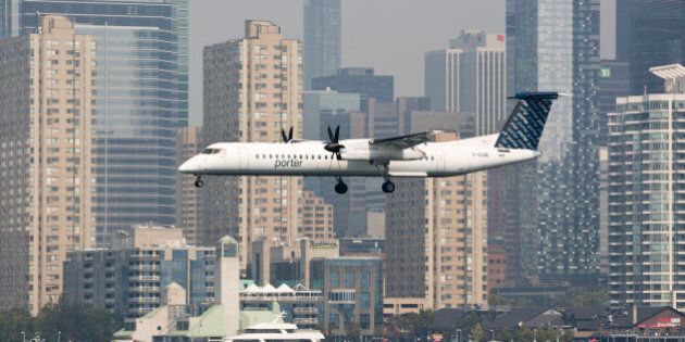 TORONTO, ON - SEPTEMBER 2: Toronto, On- Sep 2, 2015 A Porter Airline flight lands at Toronto's Billy Bishop Airport. Captain Duncan Rand runs the Mariposa's Oriole cruise ship in the Toronto harbour. (Lucas Oleniuk/Toronto Star via Getty Images)