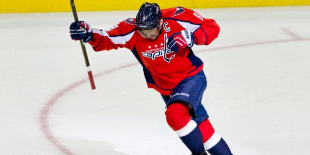 The Washington Capitals left wing Alex Ovechkin, (8), of Russia, leaps in the air in celebration after scoring his 500th career NHL goal during the second period of a hockey game against the Ottawa Senators in Washington, D.C., Sunday, Jan. 10, 2016. (AP Photo/Jacquelyn Martin)