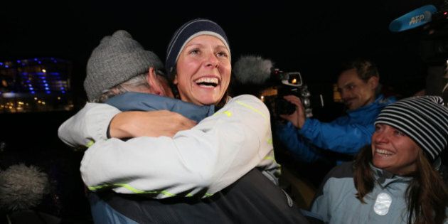 Quebec rower Mylene Paquette, center, is welcomed by her father, Jean, left, and her sister, Evelyne, right, as she arrives in Lorient, western France, Tuesday, Nov. 12, 2013, after a solo journey across the Atlantic Ocean. Paquette is the first North American woman to row solo across the North Atlantic. She left Halifax just over four months ago in a specially designed 7.3-metre boat propelled only by Paquette and the currents.(AP Photo/David Vincent)