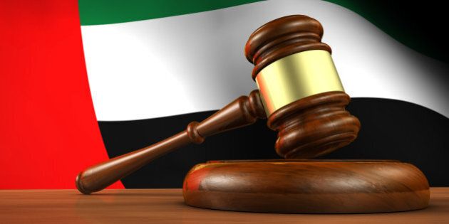United Arab Emirates law, legal system and justice concept with a 3d render of a gavel and the UAE flag on background.