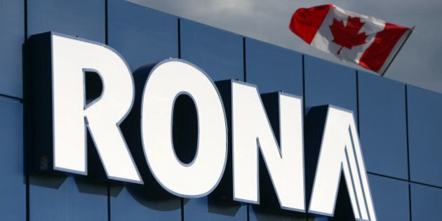 A Canadian flag flies over Rona Inc. signage displayed at the company's store in Toronto, Ontario, Canada, on Feb. 3, 2016. Lowe's Cos. agreed to buy rival Rona for C$3.2 billion ($2.3 billion) in cash to create one of Canada's biggest home-improvement retailers, almost four years after its earlier takeover proposal got rebuffed. Photographer: Cole Burston/Bloomberg via Getty Images