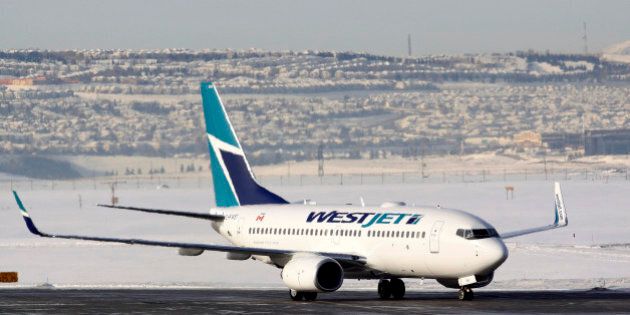 A WestJet Airlines Boeing 737-700 aircraft lands at Calgary International Airport in Alberta January 7, 2010. WestJet Airlines, Canada's No. 2 carrier, reported a record load factor on Wednesday, saying it flew fuller planes in December as it improved call center service after stumbling with a new reservation system. REUTERS/Todd Korol (CANADA - Tags: BUSINESS TRANSPORT)