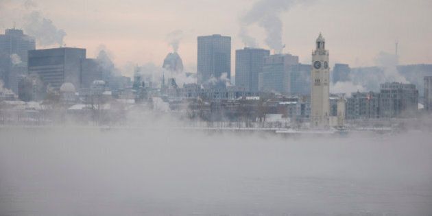 View of Montreal from the other side of St-Lawrence river by a extreme cold winter day.Smog and smoke from chimney and water vapors over the river.More in my portfolio.