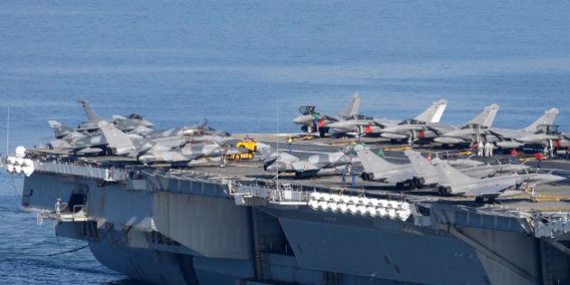 War planes are on the deck of France's nuclear-powered aircraft carrier Charles de Gaulle as it eaves its home port of Toulon, southern France, Wednesday, Nov.18, 2015. France has decided to deploy its aircraft carrier in the eastern Mediterranean sea for fighting Islamic State group.(AP Photo/Lionel Cironneau)