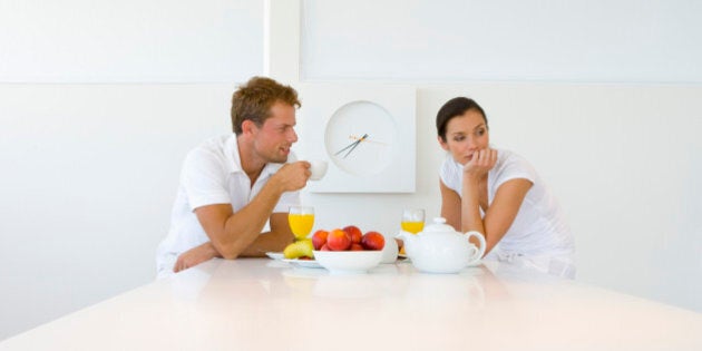 Woman ignoring man during breakfast