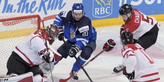 Finland's Sebastian Aho, center, in action against Canada's goalkeeper Mackenzie Blackwood, Mitch Marner, front right, and Thomas Chabot during the 2016 IIHF World Junior Ice Hockey Championships quarterfinal match between Finland and Canada in Helsinki, Finland, Saturday Jan. 2, 2016. (Markku Ulander/Lehtikuva via AP) FINLAND OUT