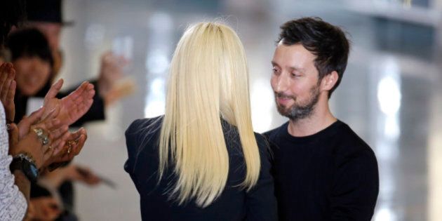 Italian designer Donatella Versace (L) greets designer Anthony Vaccarello at the end of his Autumn/Winter 2015/2016 women's ready-to-wear collection show during Paris Fashion Week March 3, 2015. Picture taken March 3, 2015. REUTERS/Charles Platiau (FRANCE - Tags: FASHION)