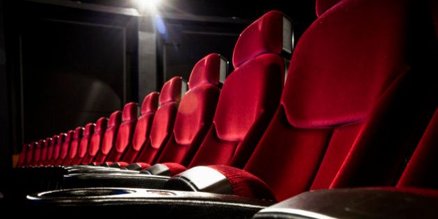 Row of red velvet seats in theater