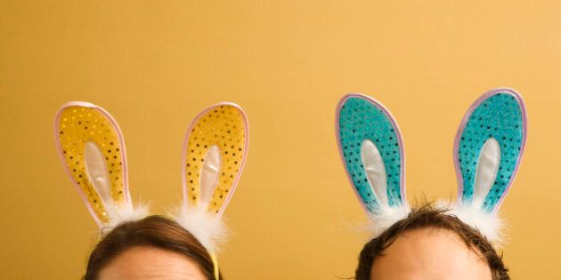 Caucasian mid adult couple wearing rabbit ears.