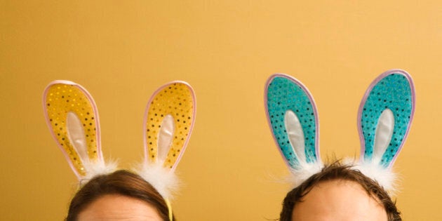 Caucasian mid adult couple wearing rabbit ears.