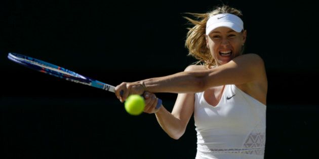 Maria Sharapova of Russia returns a shot to Serena Williams of the United States, during the women's singles semifinal match at the All England Lawn Tennis Championships in Wimbledon, London, Thursday July 9, 2015. (AP Photo/Pavel Golovkin)
