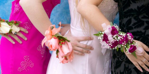 Three Women Standing Dressed for a High School Prom Wearing Corsages
