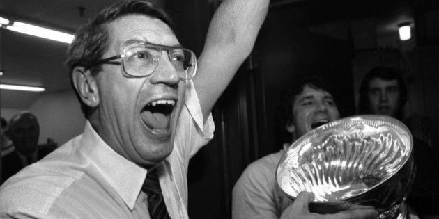 New York Islanders coach Al Arbour celebrates in the locker room as he drinks from the Stanley Cup after the Islanders won their fourth cup in a row, beating the Edmonton Oilers 4-2 to sweep the series at the Nassau Coliseum, Tuesday, May 17, 1983 in Uniondale, N.Y. (AP Photo/Pool)