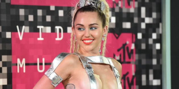 LOS ANGELES, CA - AUGUST 30: (EDITORS NOTE: Image contains nudity.) Host Miley Cyrus, styled by Simone Harouche, wearing a custom Versace outfit and boots, attends the 2015 MTV Video Music Awards at Microsoft Theater on August 30, 2015 in Los Angeles, California. (Photo by Jason Merritt/Getty Images)