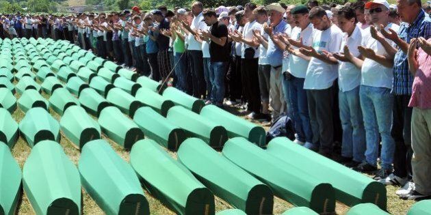 Bosnian Muslims, survivors of Srebrenica 1995 massacre pray near body caskets of their relatives, layed out at memorial cemetery in village of Potocari, near Eastern-Bosnian town of Srebrenica, on July 11, 2016. 127 newly identified bodies were be put to final rest at the Potocari memorial. Bodies are identified as those belonging to Bosnian Muslim victims, of the offensive undertaken by Bosnian Serbs in July 1995 with aim to occupy, earlier declared UN safe heaven area of Srebrenica and the surrounding villages. During the offensive more than 8000 Bosnian non-Serbs went missing to be found buried in mass graves, years after the war ended. / AFP / ELVIS BARUKCIC (Photo credit should read ELVIS BARUKCIC/AFP/Getty Images)