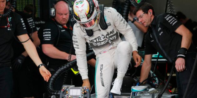 Mercedes driver Lewis Hamilton, of Britain, exits his car after a free practice for the Formula One Brazilian Grand Prix at the Interlagos race track in Sao Paulo, Brazil, Friday, Nov. 13, 2015. (AP Photo/Silvia Izquierdo)