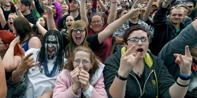 James Reed, left, brought his mother Roma Brown, both from Sioux City, Iowa, as they listen in the front row next to Robin Click, of Kansas City, to the band We Are Harlot during Rockfest on Saturday, May 30, 2015, at the Liberty Memorial in Kansas City, Mo. (John Sleezer/Kansas City Star/TNS via Getty Images)
