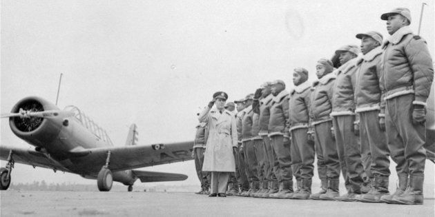 ** FILE ** Major James A. Ellison, left, returns the salute of Mac Ross of Dayton, Ohio, as he inspects the cadets at the Basic and Advanced Flying School for Negro Air Corps Cadets in this Jan. 23, 1942 file photo at the Tuskegee Institute in Tuskegee, Ala. A bomber pilot in World War II says he was shot down while being escorted by the Tuskegee Airmen, an account that supports a recent report by two historians who say the black fighter group, contrary to legend, did lose at least a few bombers to fire from enemy aircraft. (AP Photo/U.S. Army Signal Corps, file)