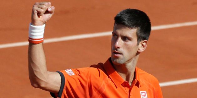 Serbia's Novak Djokovic clenches his fist after scoring a point in the quarterfinal match of the French Open tennis tournament against Spain's Rafael Nadal at the Roland Garros stadium, in Paris, France, Wednesday, June 3, 2015. (AP Photo/Christophe Ena)