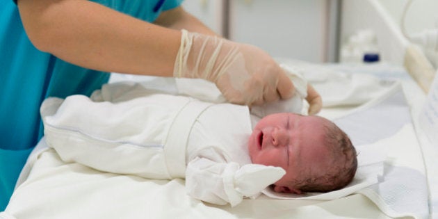 A nurse deals with newborn baby.