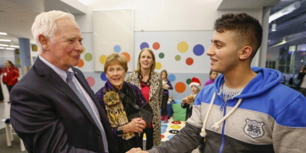 The Governor General of Canada David Johnston greets Syrian refugees at the Pearson Toronto International Airport in Mississauga, Ontario, December 18, 2015. REUTERS/Mark Blinch