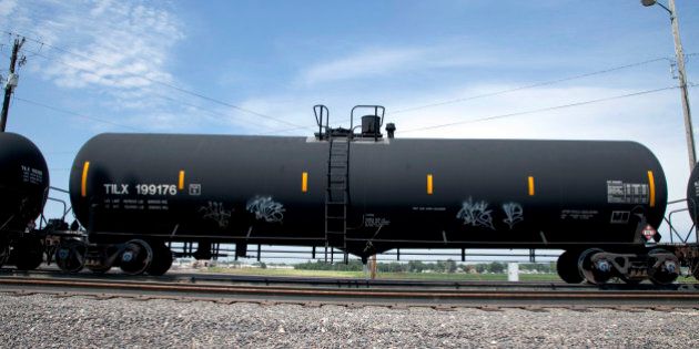 In this Aug. 8, 2012 photo, a DOT-111 rail tanker passes through Council Bluffs, Iowa. DOT-111 rail cars being used to ship crude oil from North Dakota's Bakken region are an