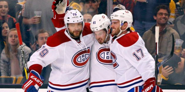 Montreal Canadiens' Paul Byron, center, is congratulated by Andrei Markov (79) and Torrey Mitchell (17) after scoring a shorthanded goal during the third period of the Montreal Canadiens 4-2 win over the Boston Bruins in an NHL hockey game in Boston on Saturday, Oct. 22, 2016. (AP Photo/Winslow Townson)