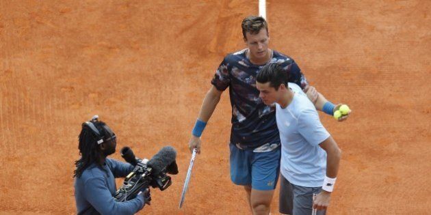Canadian tennisman Milos Raonic (C), comforted by Czech tennisman Tomas Berdych, leaves the central court after withdrawing from their quarterfinal match due to a right foot injury, at the Monte-Carlo ATP Masters Series Tournament, on April 17, 2015 in Monaco. AFP PHOTO / VALERY HACHE (Photo credit should read VALERY HACHE/AFP/Getty Images)