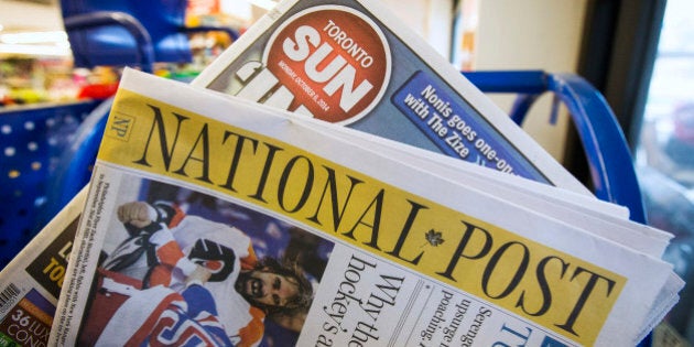 Toronto Sun and National Post newspapers are posed in front of a news stand in Toronto, October 6, 2014. Postmedia Network said on Monday it will buy Quebecor Inc's Sun Media assets for C$316 million ($282 million) in a deal that would create the dominant English-language newspaper publisher in Canada. The agreement, which will be closely scrutinized by competition authorities, would transform the country's newspaper landscape, making Postmedia the owner of competing major local dailies in cities such as Ottawa, Edmonton and Calgary. REUTERS/Mark Blinch (CANADA - Tags: BUSINESS MEDIA)