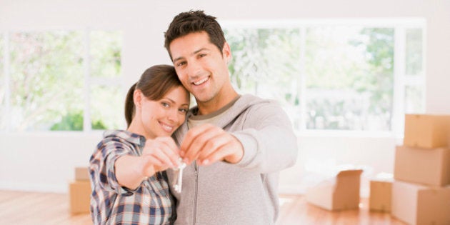 Couple holding the keys to their new house