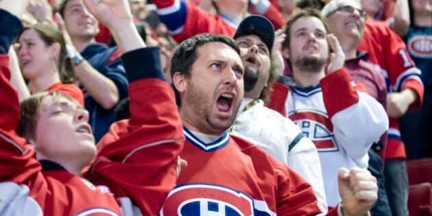 Montreal Canadiens' fan Philippe Desjardins celebrates at the Bell Centre in Montreal, Wednesday, May 12, 2010 after the Canadiens scored a first-period goal against the Pittsburgh Penguins during Game 7 of their NHL hockey Eastern Conference semifinal series in Pittsburgh. (AP Photo/The Canadian Press, Graham Hughes)