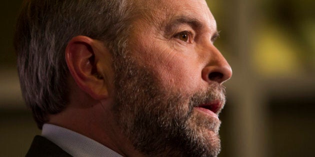 Thomas 'Tom' Mulcair, leader of the New Democratic Party, center, speaks to the media following the second...