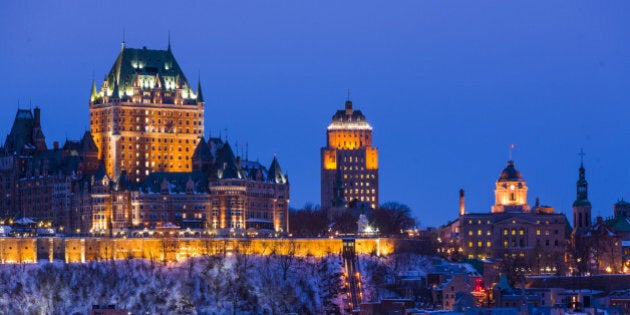 City skyline at night/twilight, showing Chateau Frontenac in winter, viewed from across the Saint Lawrence...