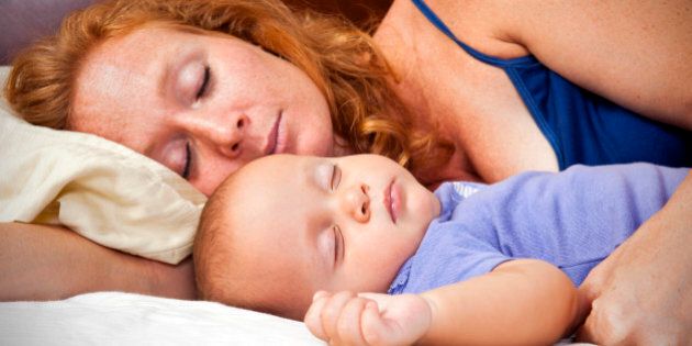 A photograph of a mother sleeping with her baby.Please browse: