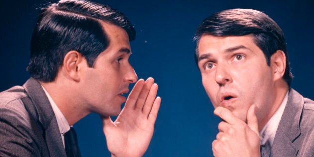 1960s DOUBLE EXPOSURE PORTRAIT OF MAN WHISPERING INFORMATION TO HIMSELF (Photo by H. Armstrong Roberts/ClassicStock/Getty Images)