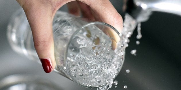 A woman fills in a glass of water on April 27, 2014 in Paris. AFP PHOTO / FRANCK FIFE (Photo credit should read FRANCK FIFE/AFP/Getty Images)