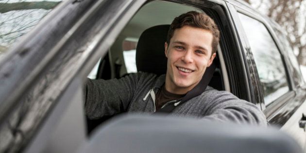 Caucasian man smiling in car window