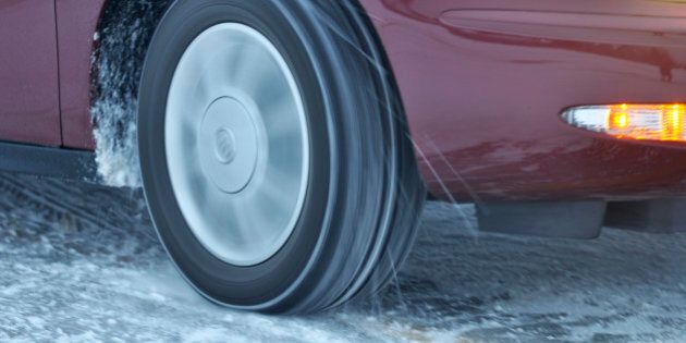 Automobile tire spinning on ice, particles flying, long exposure